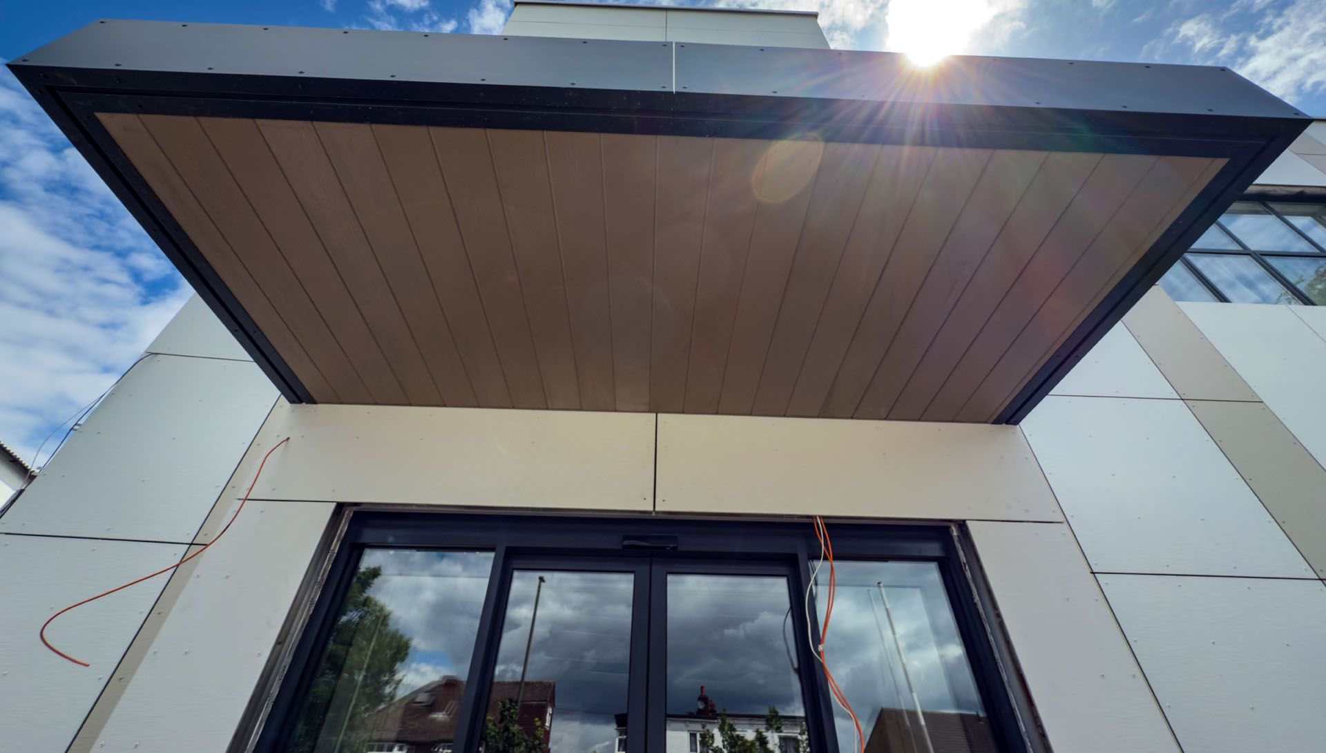 James Hardie brushed concrete cladding panels and VL Plank canopy soffit installed at Hoil Dental in Walton-on-Thames.